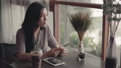 young woman resting and thinking in the cafe