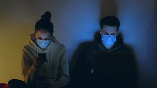 Young Adults Using Technology With Face Masks