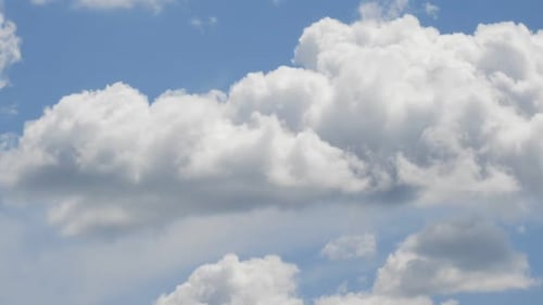Time lapse with white clouds forming on sunny blue sky