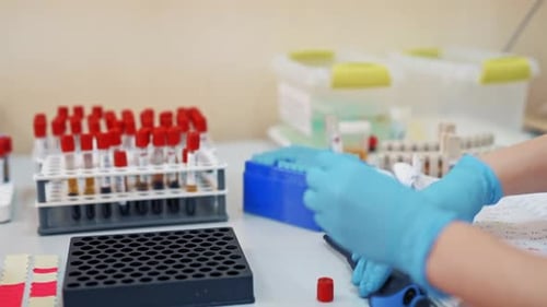 Medical Technician Extracting Sample in Laboratory
