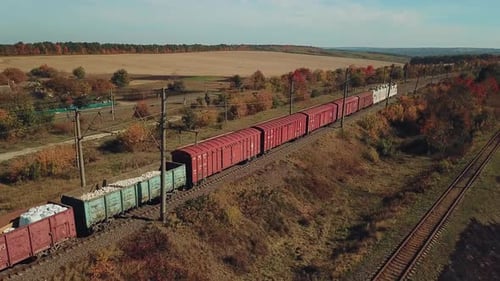 Freight Train with Building Materials is Passing by Rail to the Destination