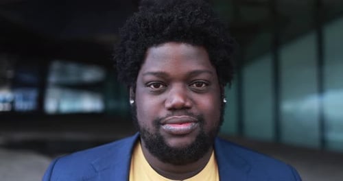 Happy african curvy man looking on camera outdoor