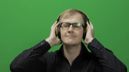 Guy Listens To Music in Wireless Yellow Headphones and Dances. Chroma Key