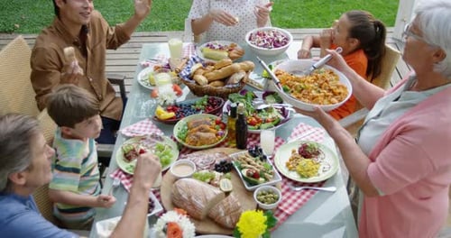 Family eating outside together in summer