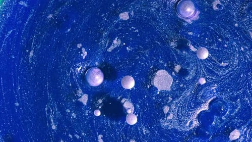Top View of Abstract Liquid Blue Swirl of Pearl Paint and Bubbles Dissolves