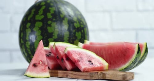 Sliced Watermelon and Whole on the Table Slowly Rotating.