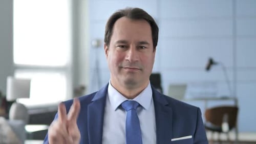 Man in Suit Makes Peace Sign