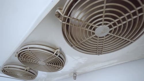 Industrial Air Conditioner with Rotating Fans on Ceiling
