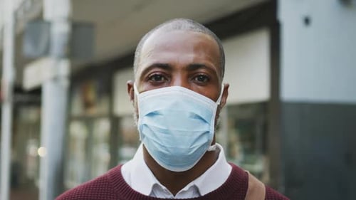 African american man on the go wearing coronavirus covid19 mask