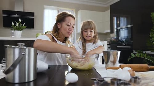 Mother and Child Baking Together in Bright Kitchen