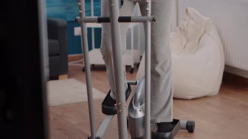 Senior Woman Working Out on Elliptical at Home