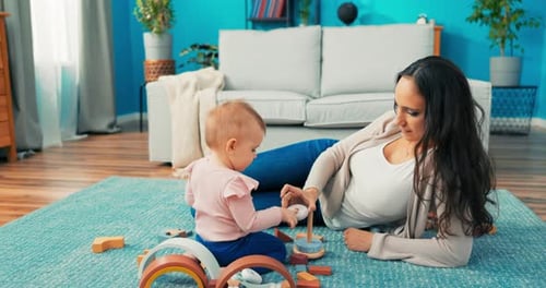 Mother and Infant Playing Together with Wooden Blocks