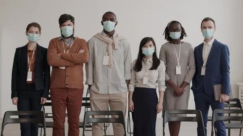 Diverse Team Wearing Masks Posing in Workplace