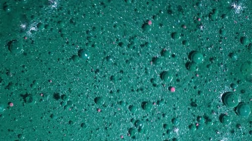 Top View of Abstract Liquid Teal Swirl of Pearl Paint and Bubbles