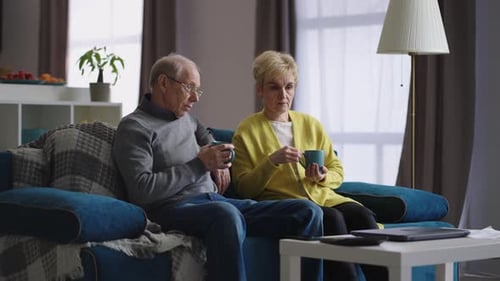 Senior Couple Enjoying Coffee and Conversation at Home