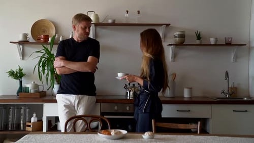 Couple Preparing Drinks in a Modern Kitchen