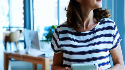 Female executive using digital tablet in office