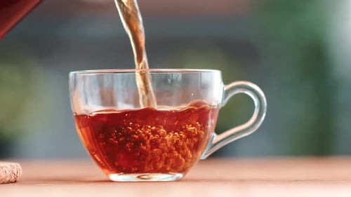 Pouring Tea into a Clear Teacup