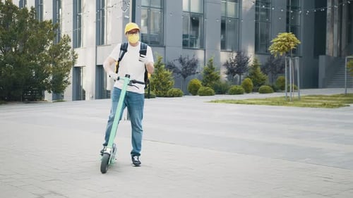 Delivery Driver with Scooter Using Smartphone in City
