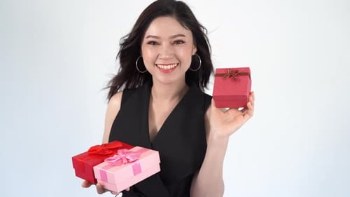 Woman Smiling and Holding Birthday Gifts in Studio