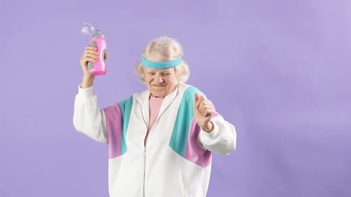Energetic Senior Woman Dancing with Water Bottle