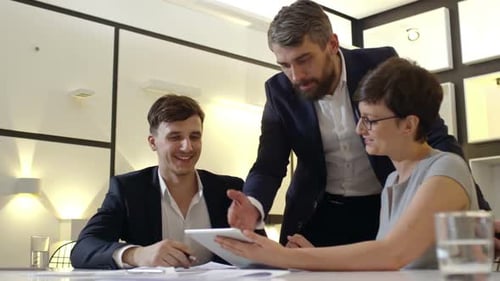 Colleagues Working Together at a Modern White Table