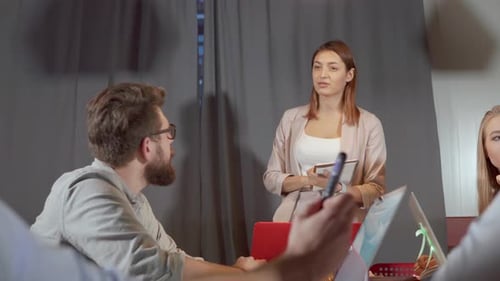 Woman Giving Presentation at Corporate Business Meeting