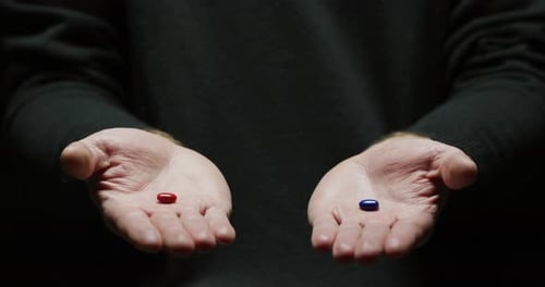 Hands Presenting a Red and Blue Pill