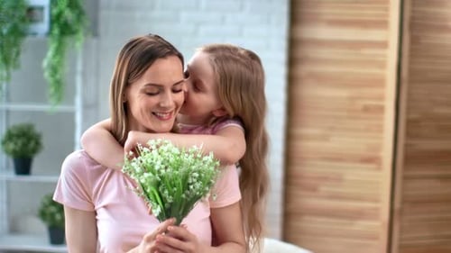 Little Girl Giving Affection to Loving Mother