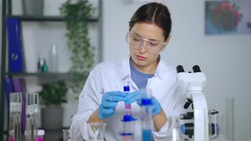 Woman Scientist Conducts Experiment in Laboratory