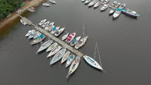 Aerial View on a Yaght and Boats Parking in a Calm Bay