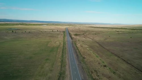 Aerial View of an Empty Intercity Asphalt Road in Rural Area Road Between Fields with Rare Trees