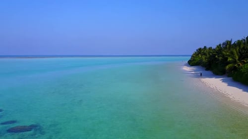 Drone aerial texture of coastline beach by blue lagoon with sand background