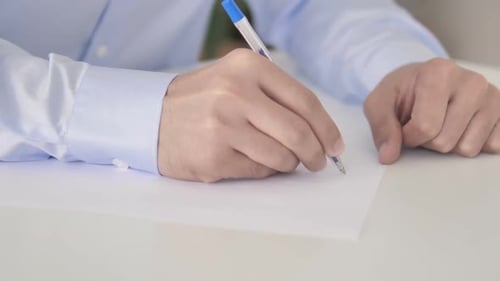 Close Up of Person Writing Business Plan