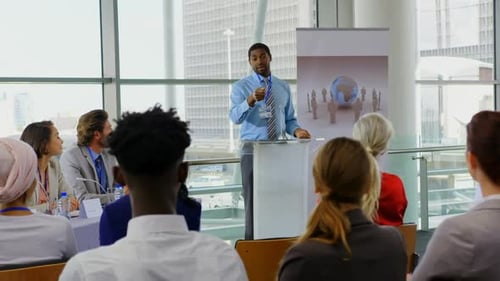 Man Speaking at Business Conference with Audience