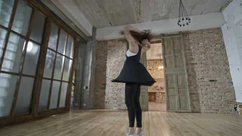 Energetic Woman Dancing Freely in an Open Studio