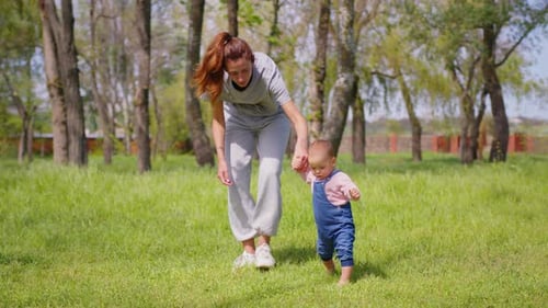 Baby's First Steps with Mother in the Park
