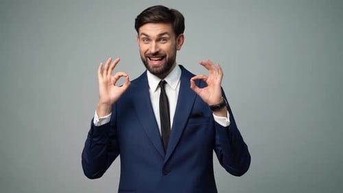 Man in Suit Makes OK Sign with Both Hands