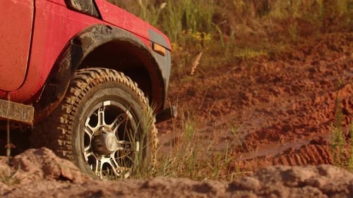 Large SUV Drives Through Mud and Runs Into Huge Puddle Closeup Side View