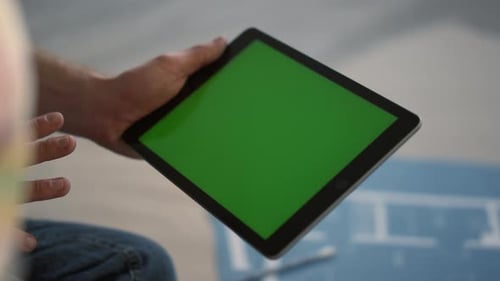 Unknown Man Holding Tablet Indoors