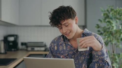 Young Adult Working on Laptop at Home
