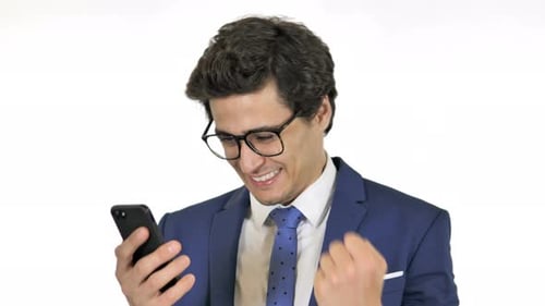 Happy Young Man Celebrating Good News on Phone