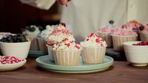 Close up of Decorating Cupcakes with Sprinkles