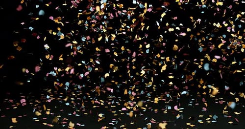 Confettis Falling against Black Background, Slow Motion 4K