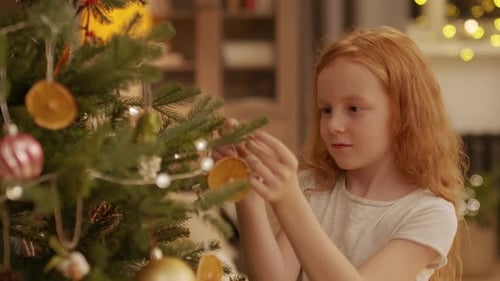Little Girl Decorating Christmas Tree