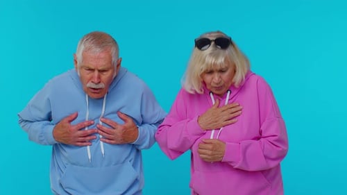 Seniors Expressing Pain and Discomfort Against Blue Backdrop