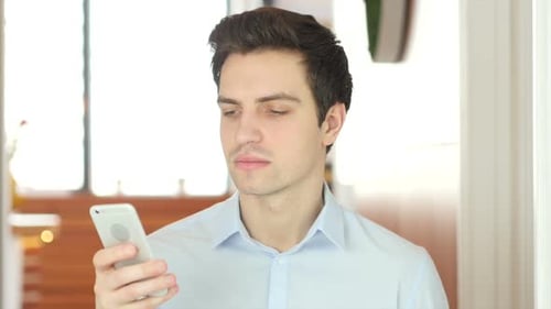 Man Using Smartphone at Work