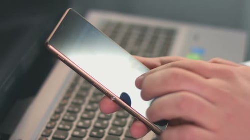Man Browsing Internet, Selecting, Watching Video on Smart Phone