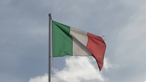 Italian Flag Waving Against Partly Cloudy Sky