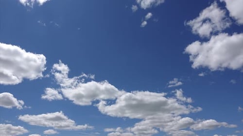 Sunlight passes through the white clouds hovering in the summer sky, Timelapse